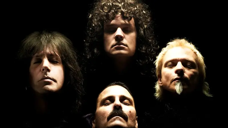 The four members of Almost Queen lit from above against a black background, posed like the cover of Queen's 'Queen II' album