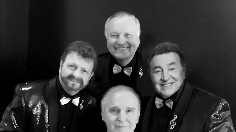 Black-and-white portrait of the four members of The Fabulous Acchords in tuxedo jackets